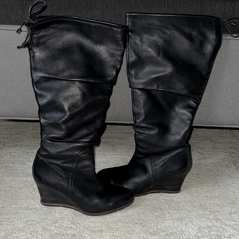 Tall black leather wedged boots